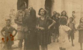Harold 'Bill' Williams pictured with a local family and other civilians, Italy