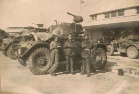 A Staghound Armoured Car in Haifa, Palestine, with members of 3rd, The King's Own Hussars, date unknown.