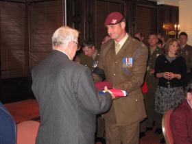 The OC of C (Bruneval) Coy presents Maj Timothy's nephew with a Union Flag and Parachute Regiment Beret, 3 Nov 2011
