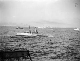 Italian lighters and tugs assist in unloading Royal Navy ships in Taranto Harbour, September 1943.
