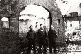 Three men including Sgt 'Johnny' Peters (left) at the 1st Bn, Border Regiment (Airborne) HQ, Oosterbeek 1944.