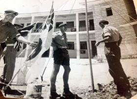 Putting up the Combined Services Flag outside 16th Parachute Brigade Headquarters, Jordan, 1958.