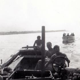 Pte Len Wright at the helm with members of 1 PARA, river patrol, c1956.