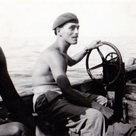Pte Len Wright 1 PARA, at the helm on a river patrol, c1956. 