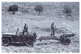 Jeep and 75mm howitzer limbering up at end of shoot live firing practice shoot, Palestine, 1947