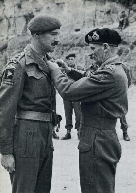 Lt Col Bruce Harvey receiving his DSO from Gen Montgomery, 1944.
