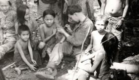 Medic attending the villagers, Borneo, 1965.