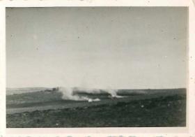 German patrol cars burning on the Beja road.