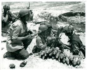 Men operating 3 inch mortars.