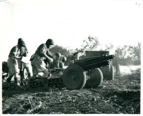 Airborne gunners operate a US 75mm pack gun.
