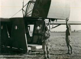 Men of the Border Regiment demonstrate method of unloading equipment from a Waco glider. June/July 1943.
