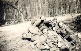 Five paratroopers have a roadside rest on the way to Wismar.