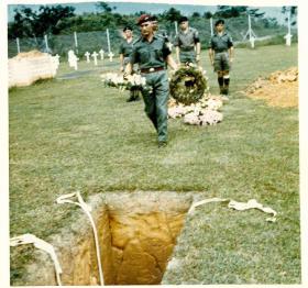 Wreath being placed at the reinterrment of Sgt McNeilly, Kranji Military Cemetery, 1975.