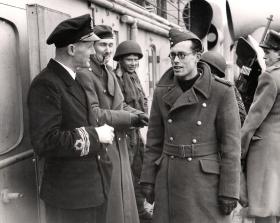 Commander HB Peate, of HMS Prins Albert, talks with Flt Lt DH Priest after the operation, Bruneval, 1942.