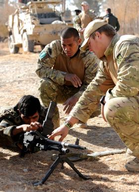 Soldiers from 3 PARA instructing an Afghan Soldier on the GPMG, Afghanistan, 2011