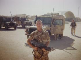 Pte Edwards on base carrying a 'Minimi', Iraq, 2005.