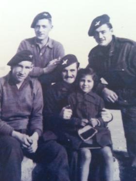 Men of 6th (Royal Welch) Parachute Battalion with a child, undated.