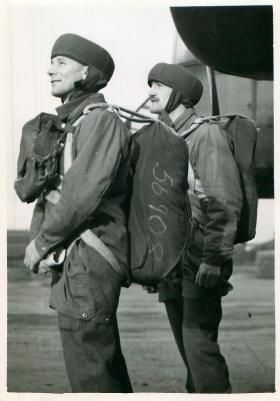 Posed shot of two equiped paratroopers ready to emplane.