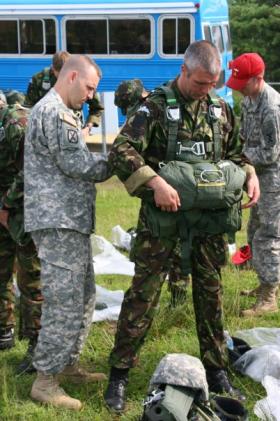 Steve Kinsella having a jumpmaster safety check prior to a jump from a Chinook, USA, undated.
