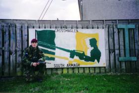 Mark Magreehan beside some sectarian graffiti, Crossmaglen, South Armagh, Northern Ireland
