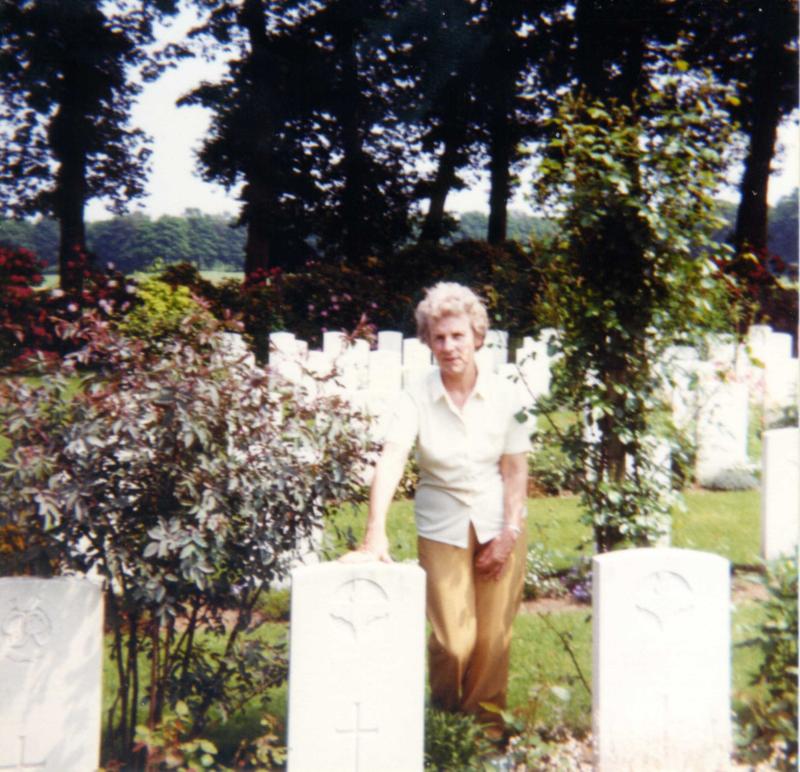 Colour image of Pte Cartmans sister at his grave, 1980s.
