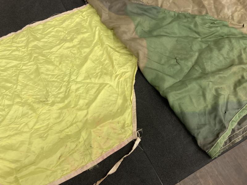 Colour image of 2 silk scarves, one in camo material and one bright yellow.