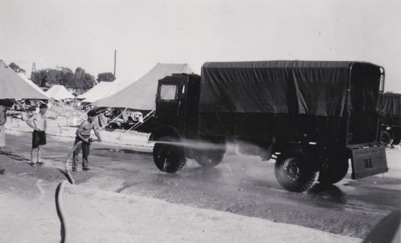 OS 1951-06-27 Pte Mc Gowan,MT platoon,3 Para, washing down 3 tonner,my tent on left-rear stayed dry