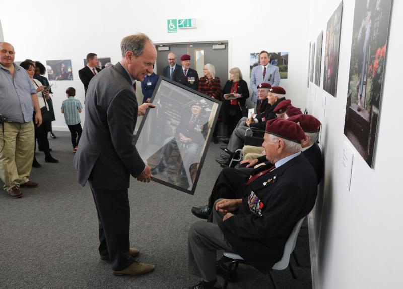 AA Jacko Page presenting framed photos to each veterans