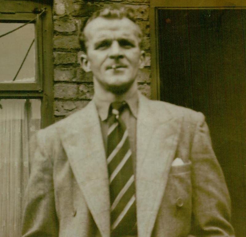 A black and white photo of William Beck in a suit