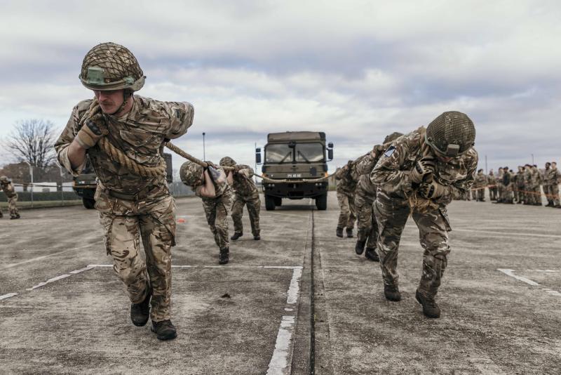 OS REME men using ropes to pull large lorry