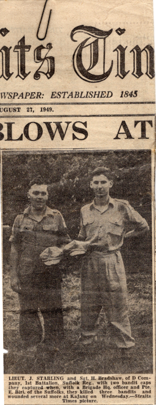 Image of Brig. Joe Starling and Sgt. Bradshaw posing with captured caps in Malaya, 1949