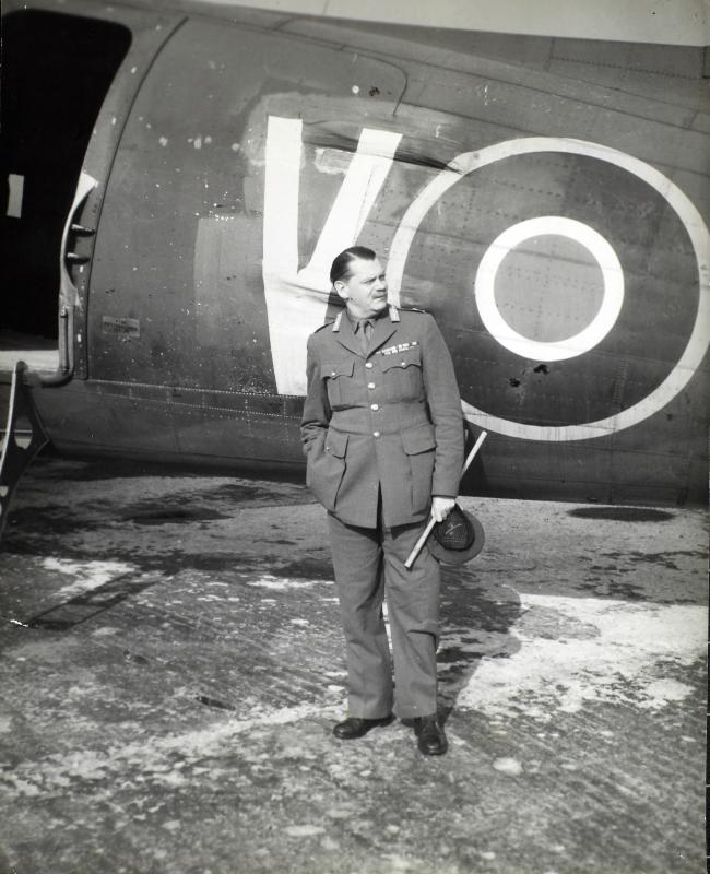 Photograph of Richard Gale standing in front of plane
