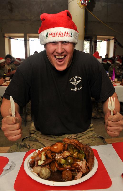 A soldier from 3 PARA Support COY enjoys Christmas Dinner, Patrol Base Shizad, Afghanistan, 25 December 2010