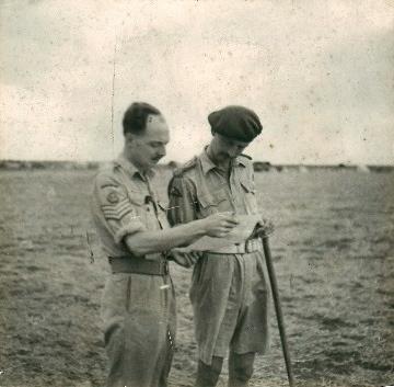 Brigadier Prichard reads a document with the brigade chief clerk.