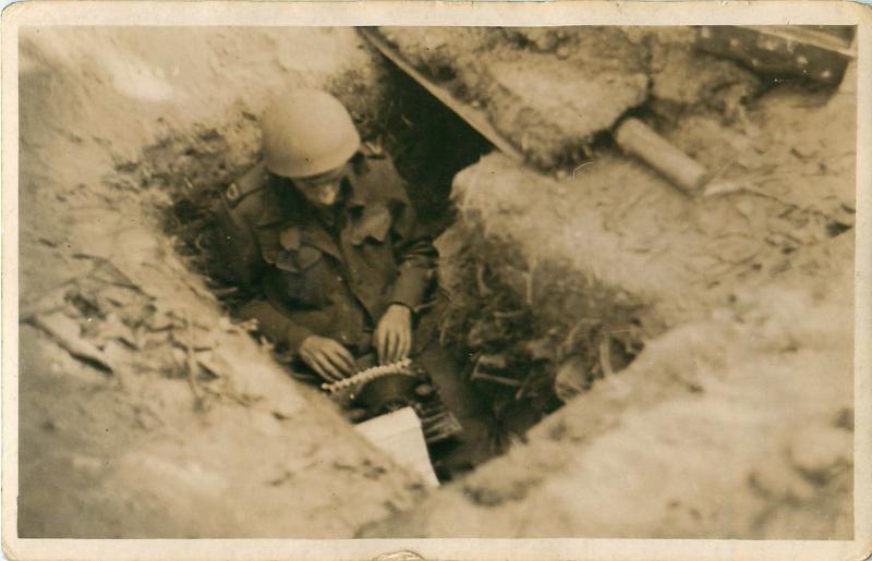 War correspondant Alan Wood sits in a trench with his typewriter in the grounds of the Hartenstein Hotel.