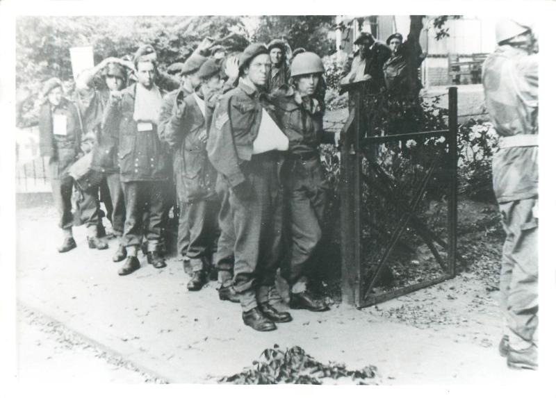 Captured British paratroopers marched out of the Vreewijk Hotel after he bitter fighting in Oosterbeek.