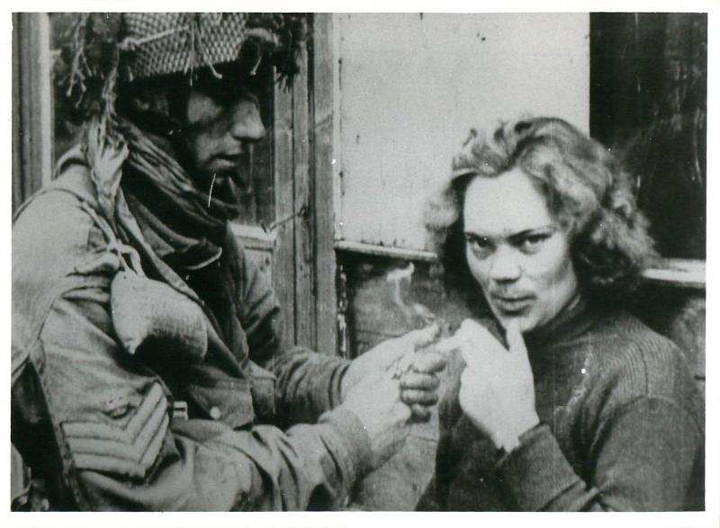 A British Glider pilot lights the cigarette of a female German telegraphists taken PoW.