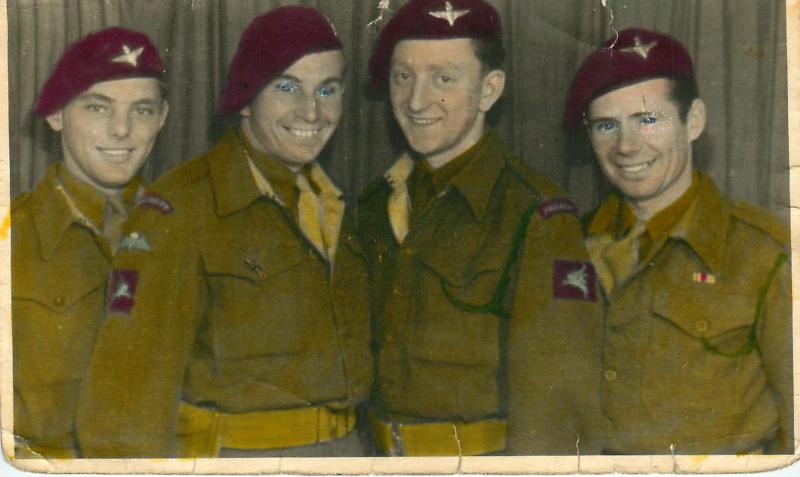 Four British paratroopers smile for the camera in Norway, 1945.