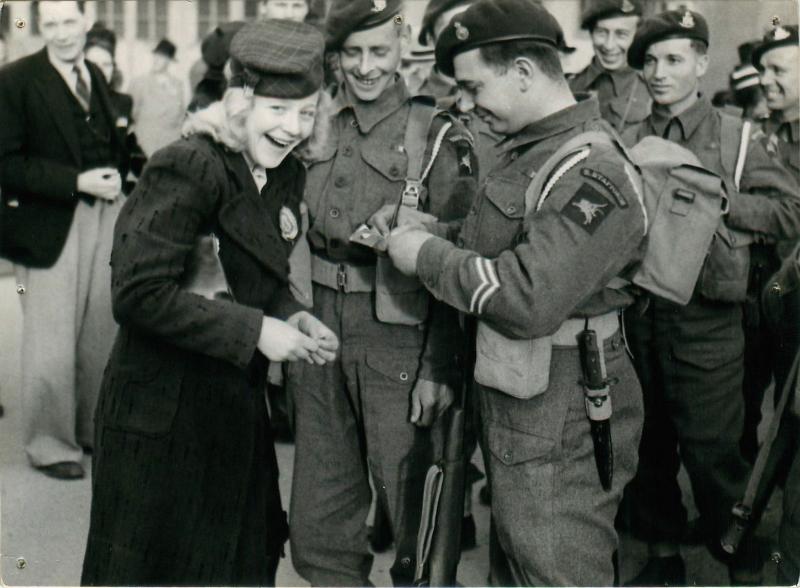 A Norwegian girl obtains autographs from men of the 1st Airborne Landing Brigade.