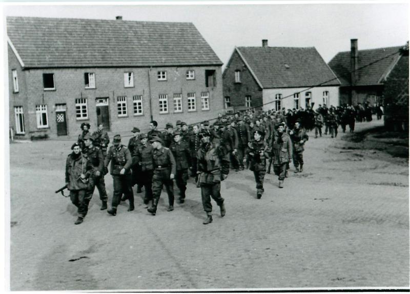 Glider pilots with German prisoners near Hamminkeln railway station, March 1945.