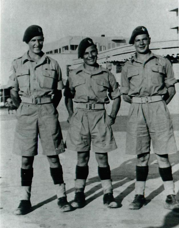 One paratrooper and two RAMC soldiers pose for the camera in Palestine, 1946.