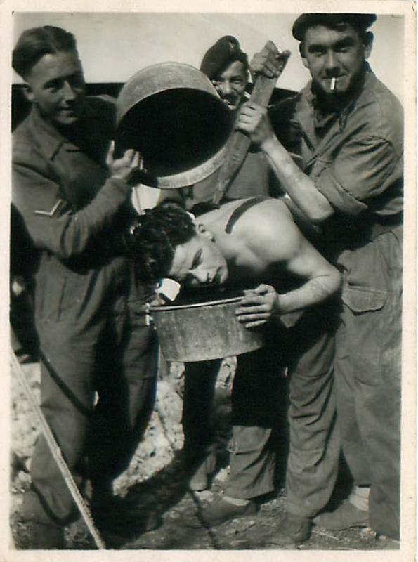 Four men from 8 PARA wash and relax in a camp outside Haifa, 1946/47.