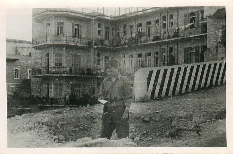 Airborne soldier reads IZL pamphlet found in waste ground in Haifa, 1948.