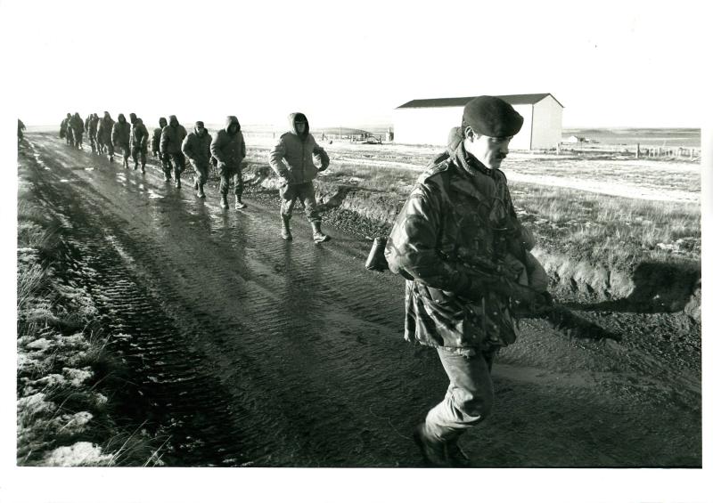 Argentinian prisoners are led away by British paratroopers.