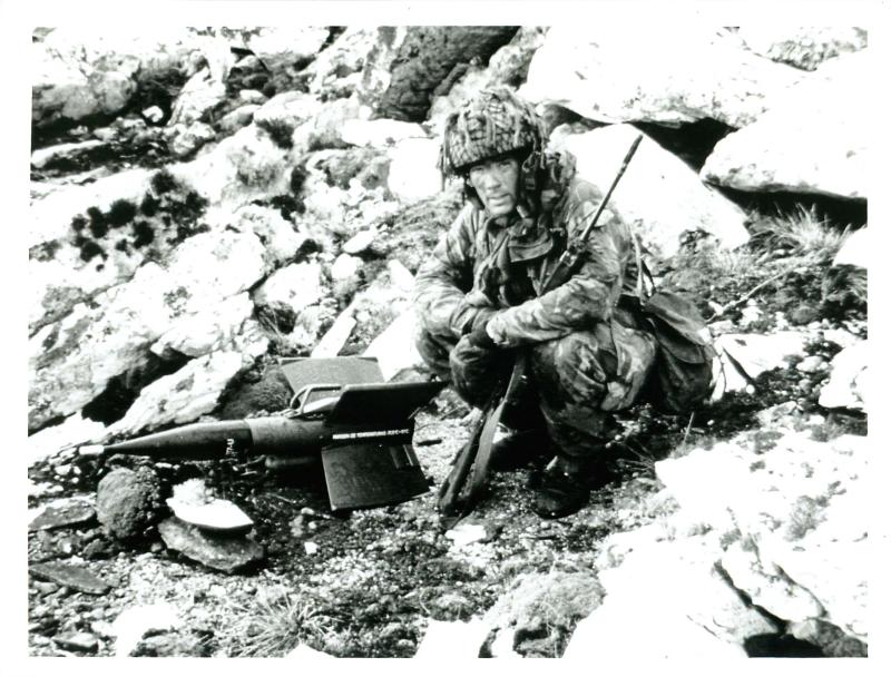 Sgt Graham Colbeck, 3 PARA, examines anti-tank missile on Mount Longdon.