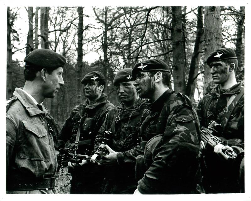 Prince Charles talks to four armed members of the Parachute Regiment 