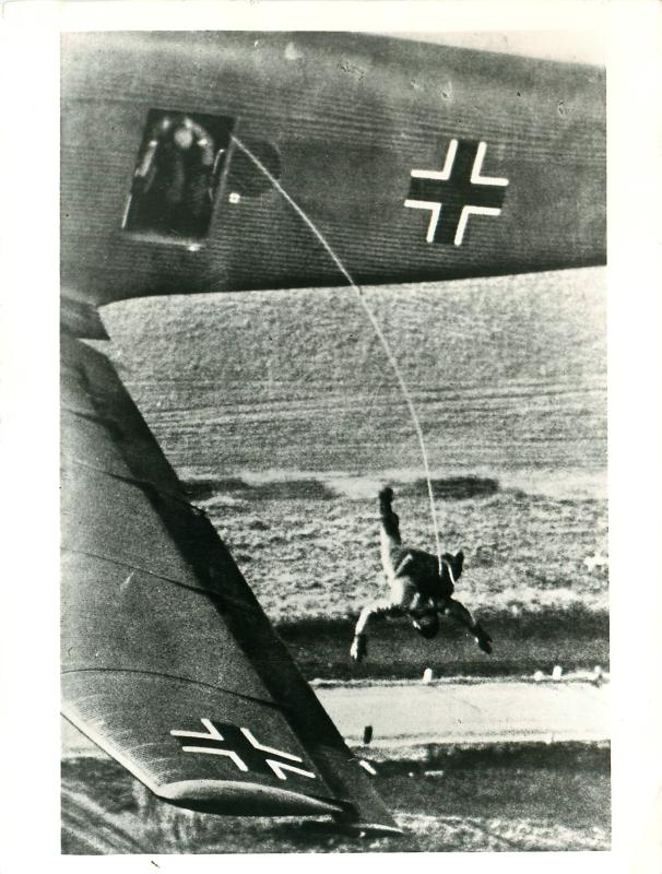 The first of a stick of German paras exits the aircraft.