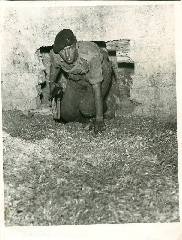A paratrooper searches a farmhouse in Cyprus.