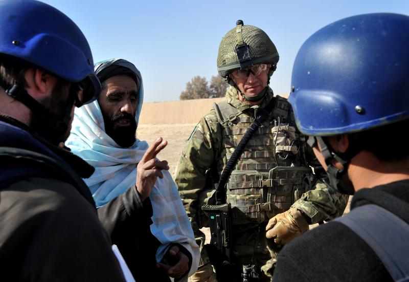 A soldier from 3 PARA talks with locals, Afghanistan, 2011