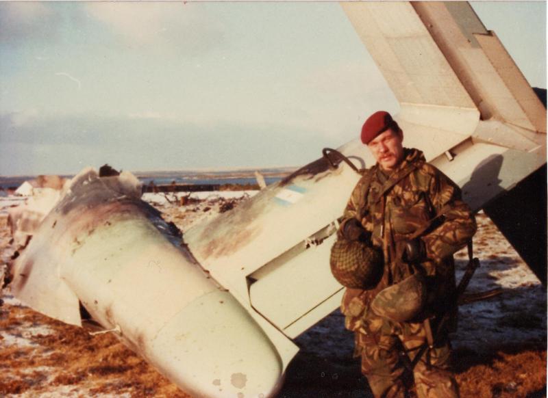 'Yank' Thayer standing next to Argentinian Pucara A-527 at Goose Green, blown apart by a Cluster Bomb Unit (CBU)